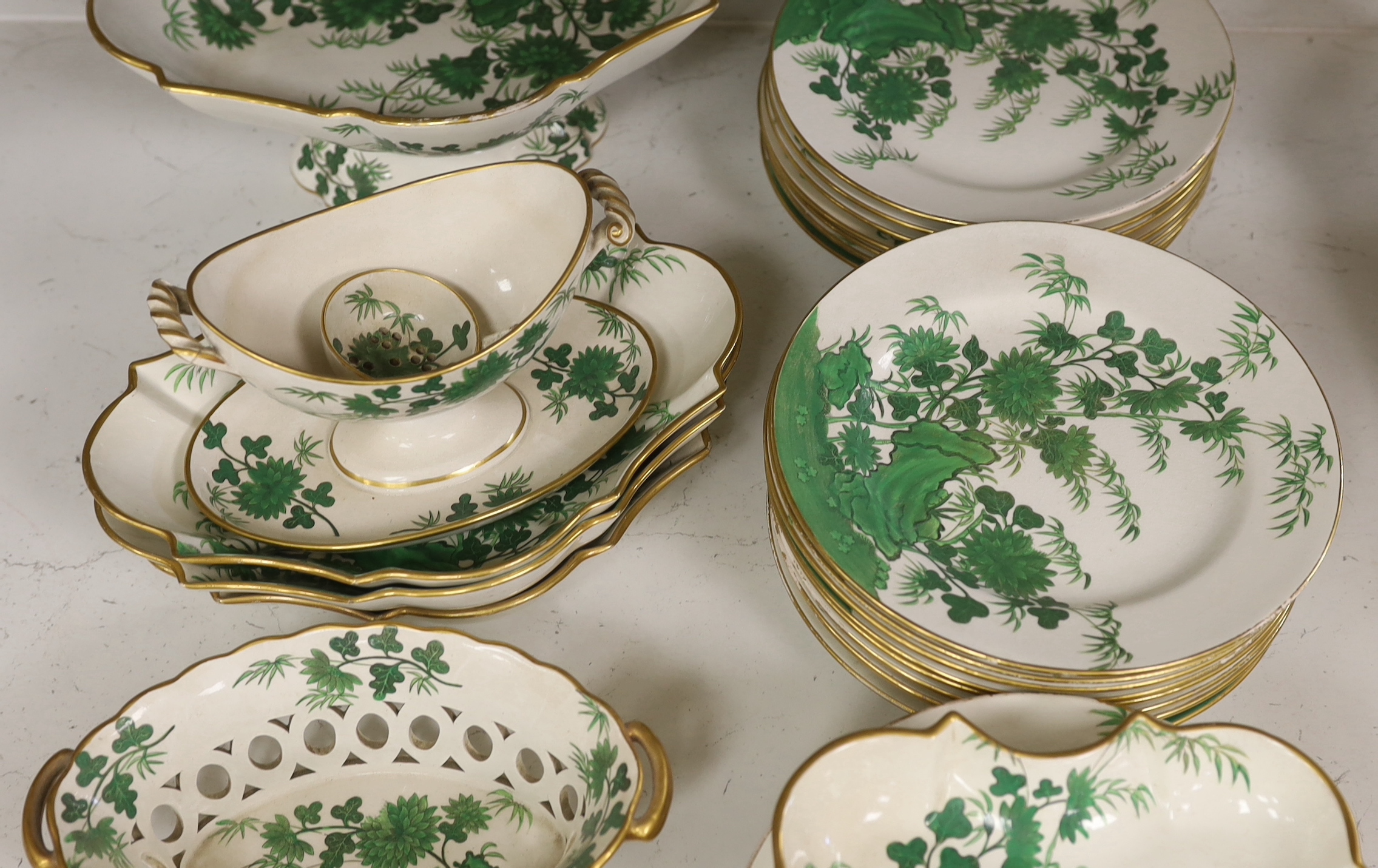 An early 19th century thirty-six piece part dessert service decorated with flowers, the largest 30cm wide